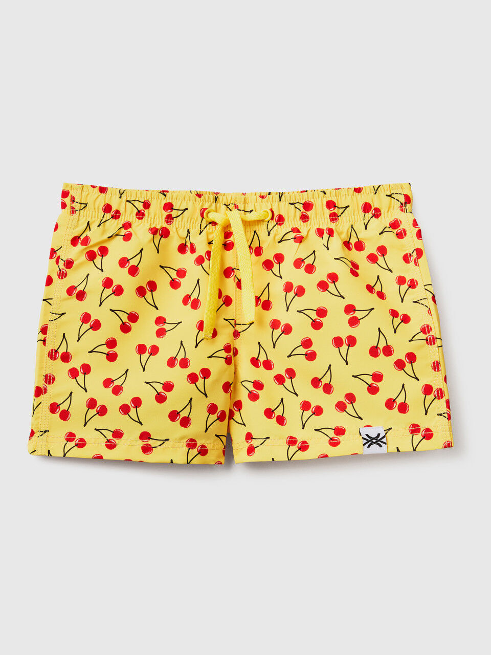 Yellow swim trunks with cherry pattern