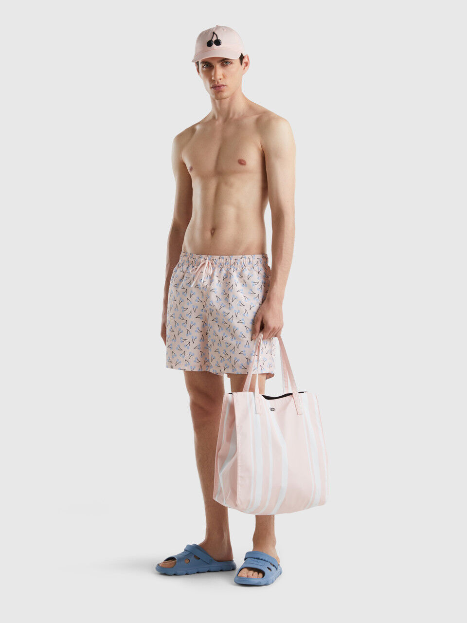 Light pink swim shorts with cherry pattern